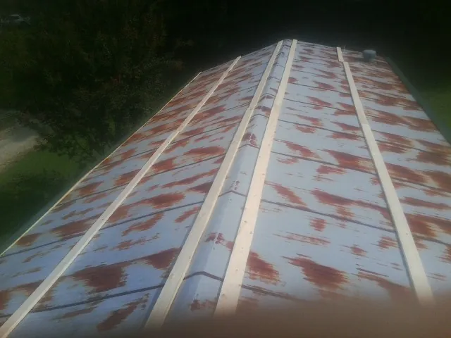 Rusted metal roof panels with new wood purlins before replacement — Storm Damage Roof Repair in Dublin by Roofing Brothers