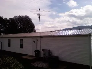 New metal roof on a single wide mobile home with a TV antenna in Dublin